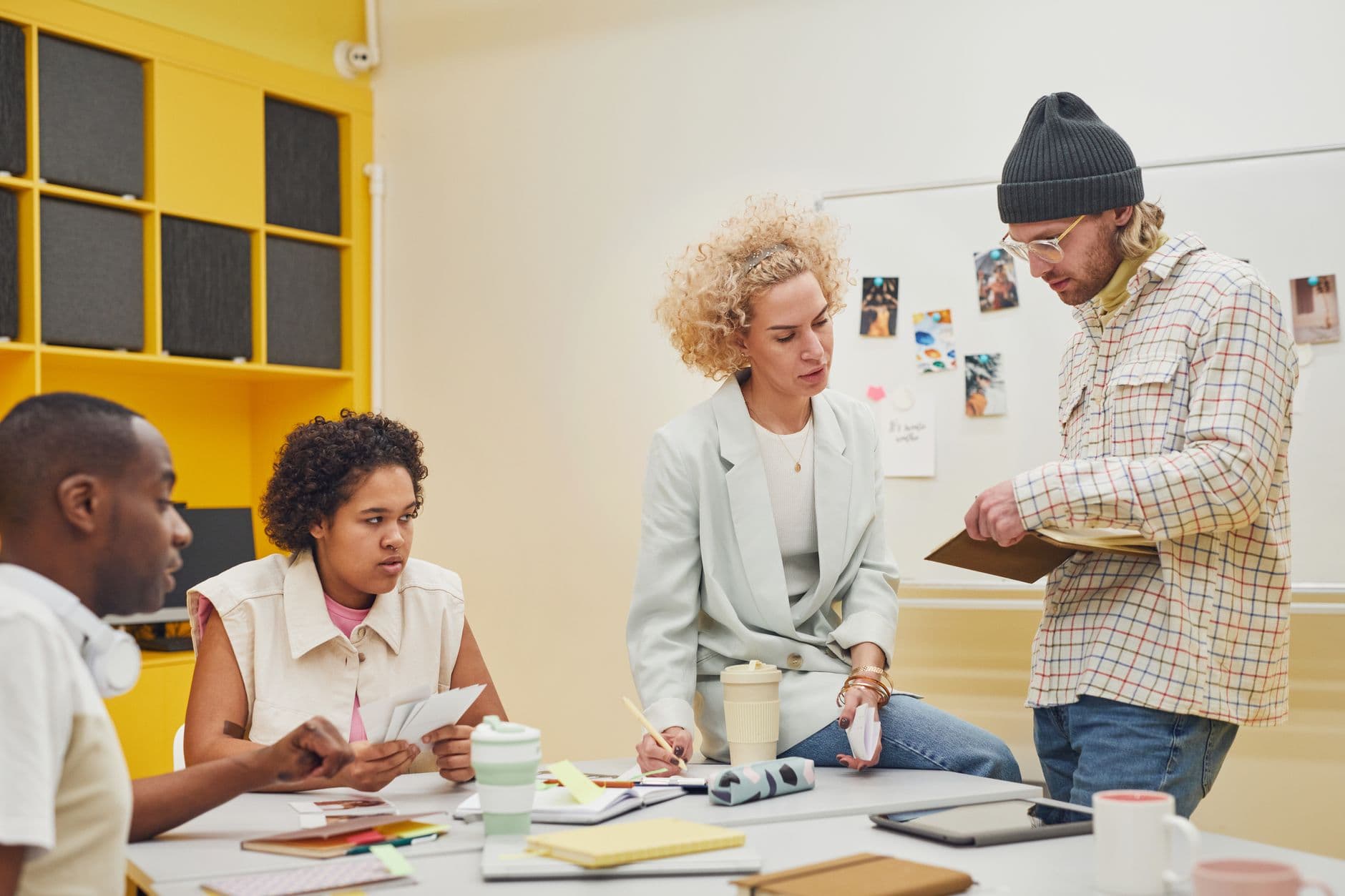 Cloud Hosting for Digital Agencies — Diverse team brainstorming in a modern office setting, discussing ideas and teamwork.