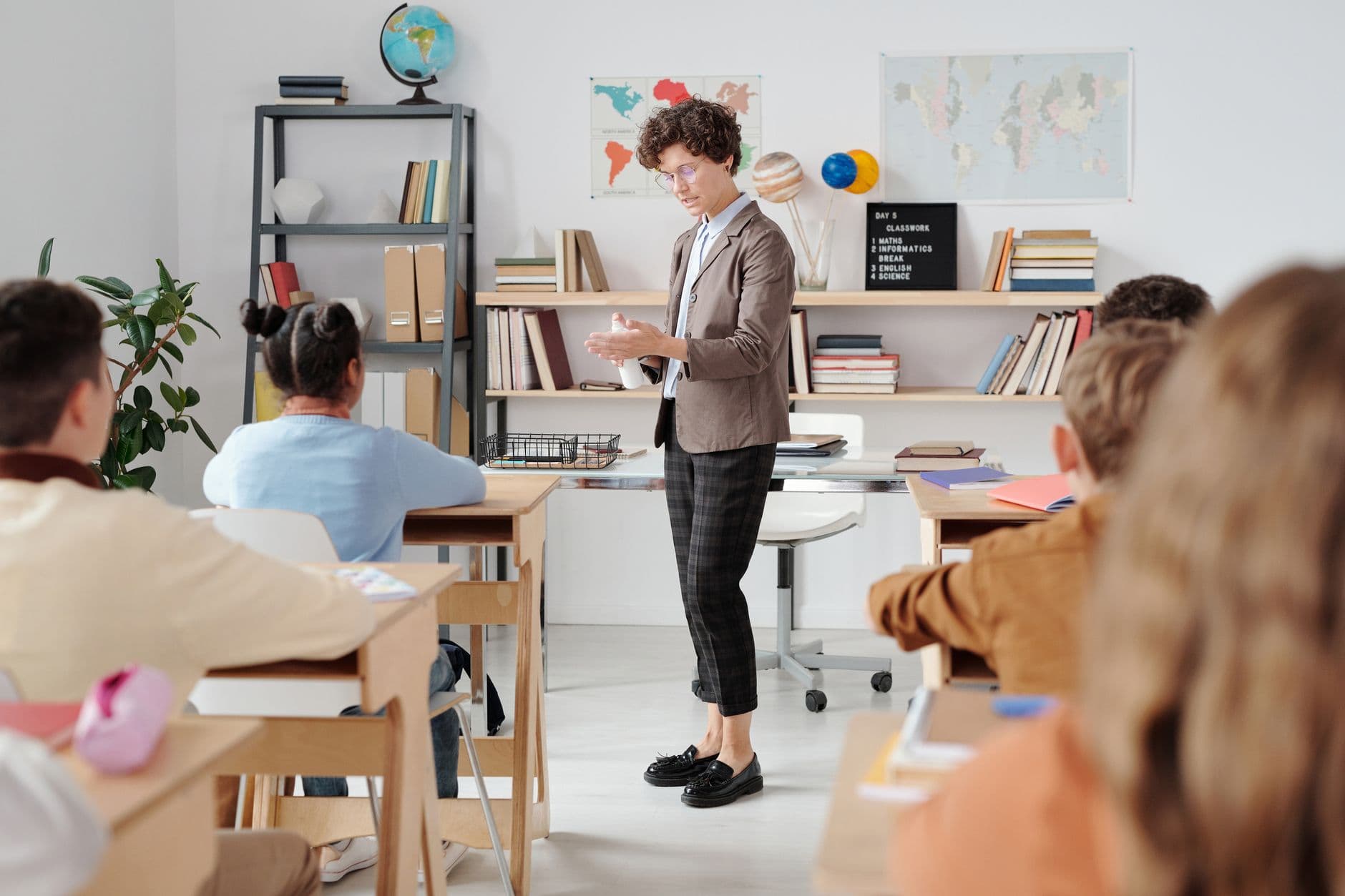 Coaching Institute Websites — Teacher conducting a classroom lesson with attentive students in a vibrant educational setting.