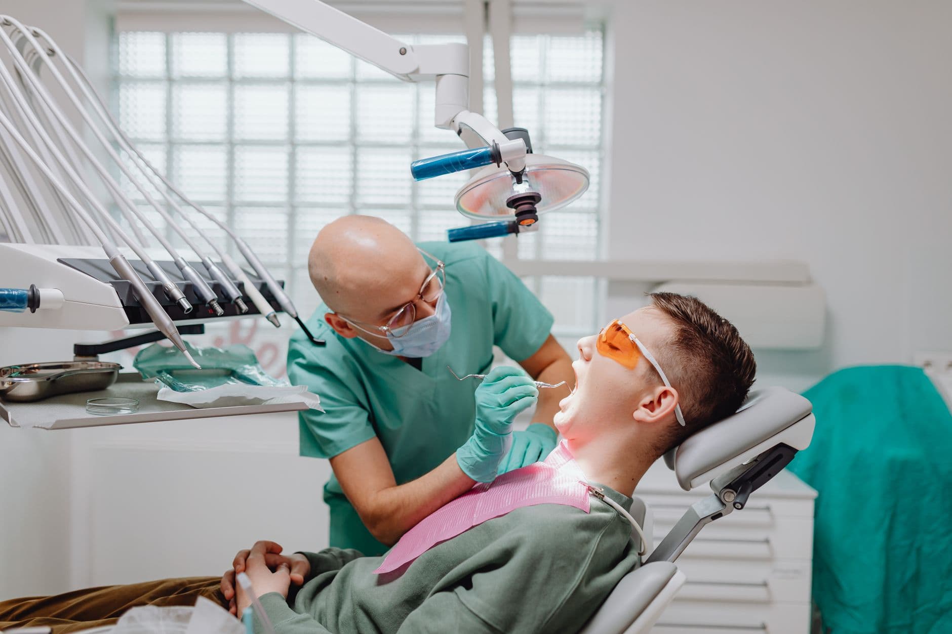 Dentist Appointment Websites — Patient receives dental check-up from experienced dentist in a modern clinic.