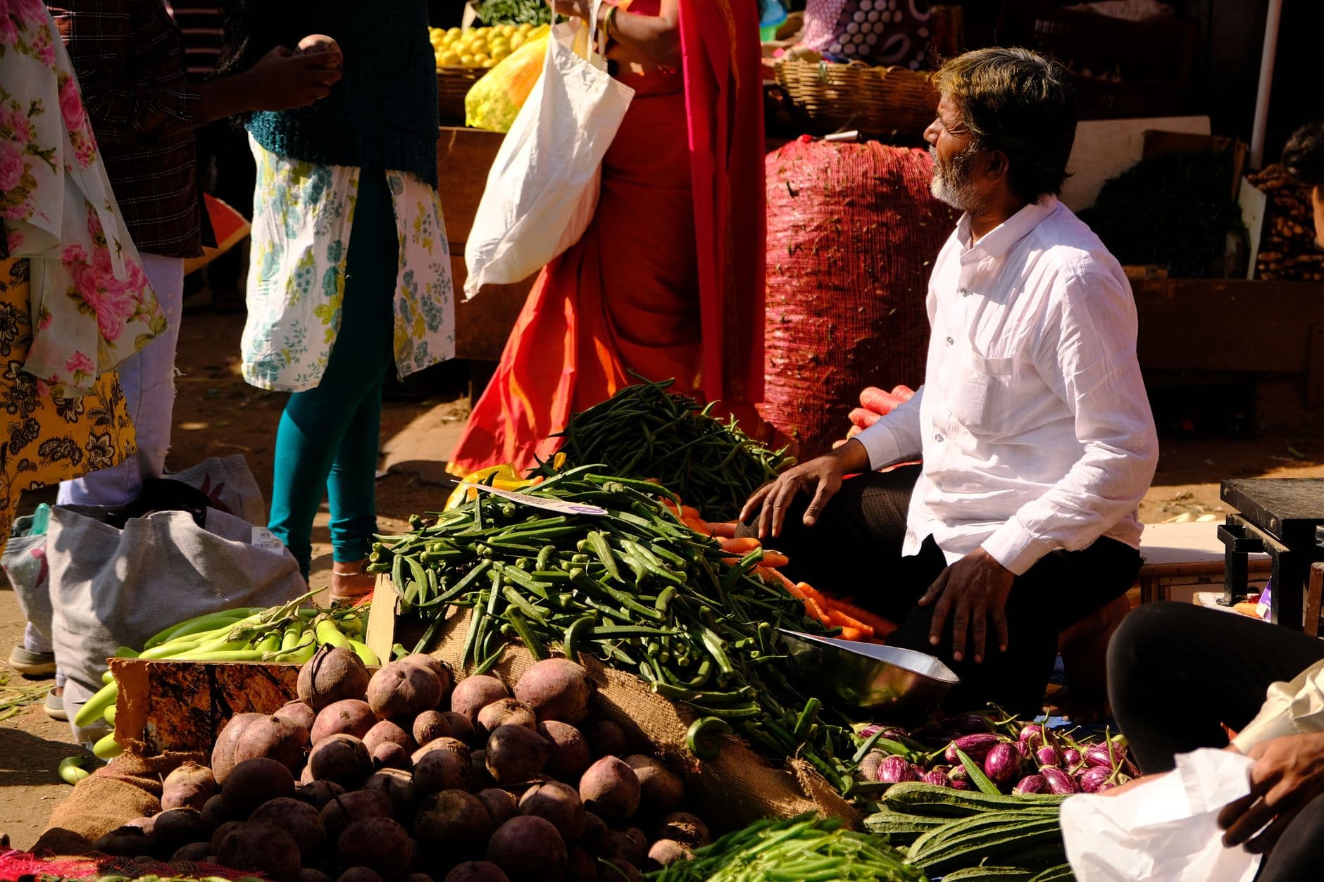 Grocery & Quick Commerce Websites — Colorful vegetable market scene in Bengaluru, India with diverse shoppers and fresh produce.