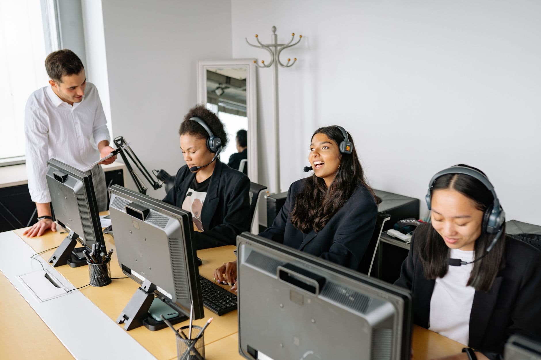 RDS Solutions for Call Centres & Software Teams — A diverse team of customer service representatives working in an office setting, wearing headsets and using computers.