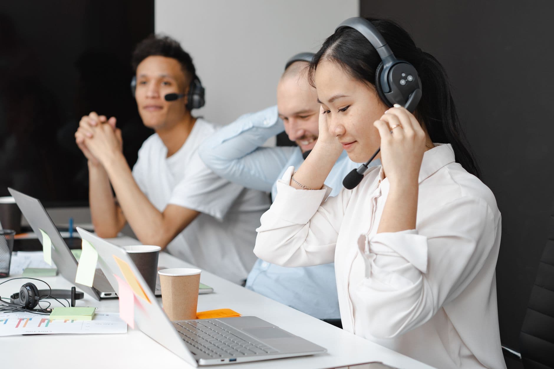 RDS Solutions for Call Centres & Software Teams — Diverse team of call center agents using laptops and headsets in a modern office setting.