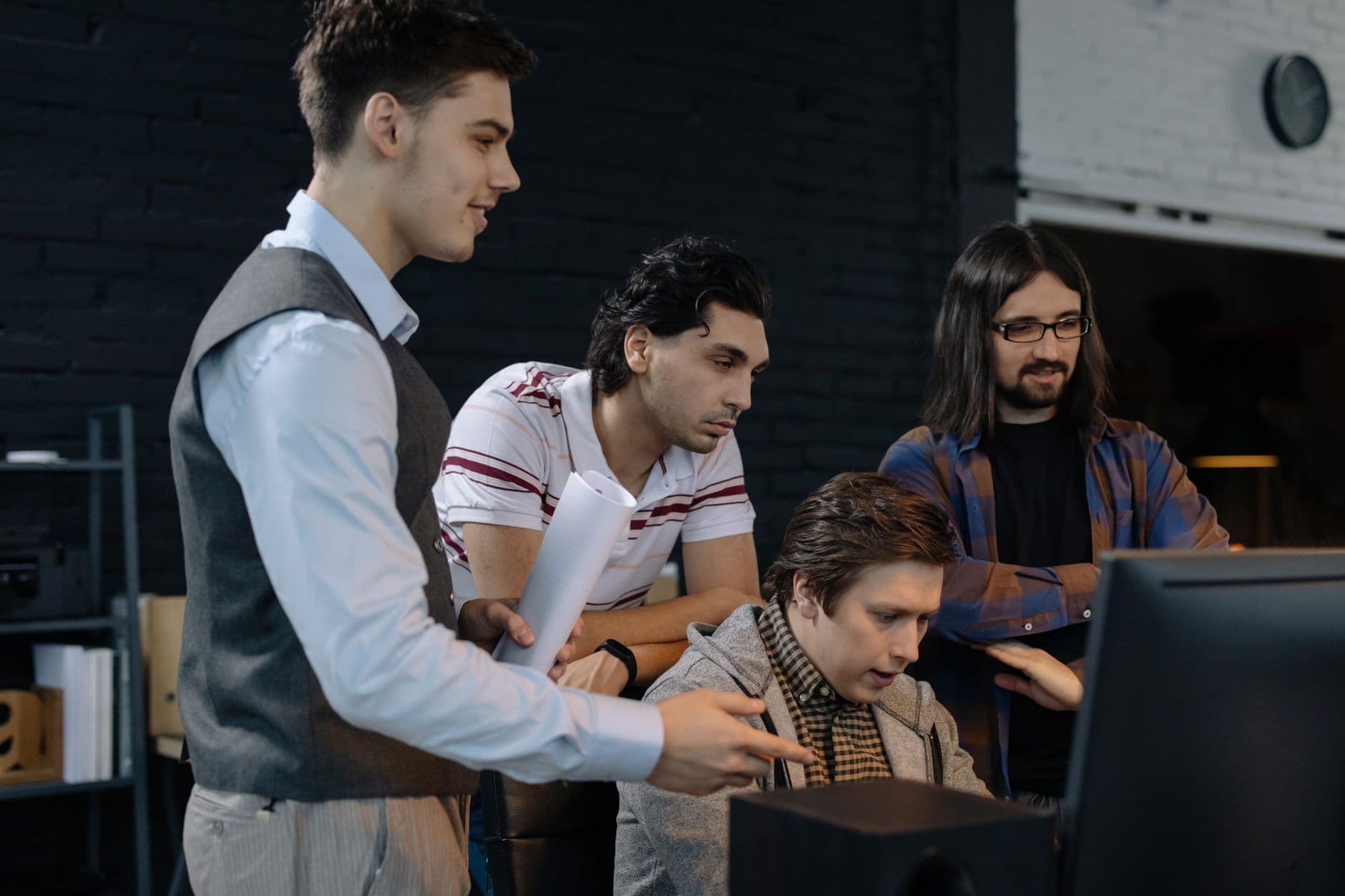 VPS Hosting for Software Companies — Group of young professionals collaborating on a project in a modern office environment.