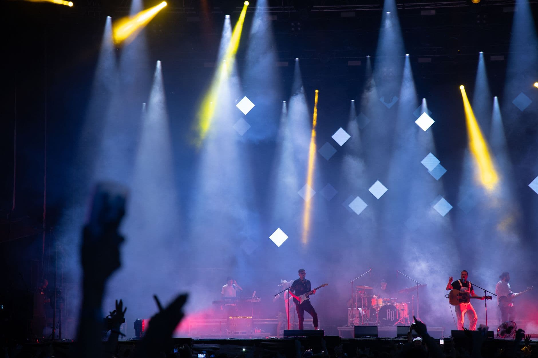 VPS Hosting for Ticket Booking Software — Energetic live performance featuring a band on stage under vibrant lights and smoke effects.