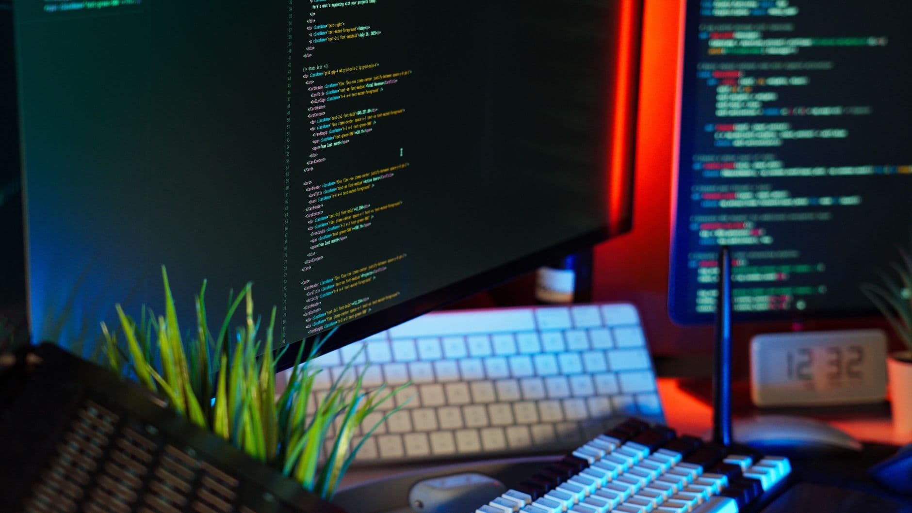 VPS Hosting for Web Designers — A vibrant workspace showing computer monitors with code, keyboard, and tech accessories.