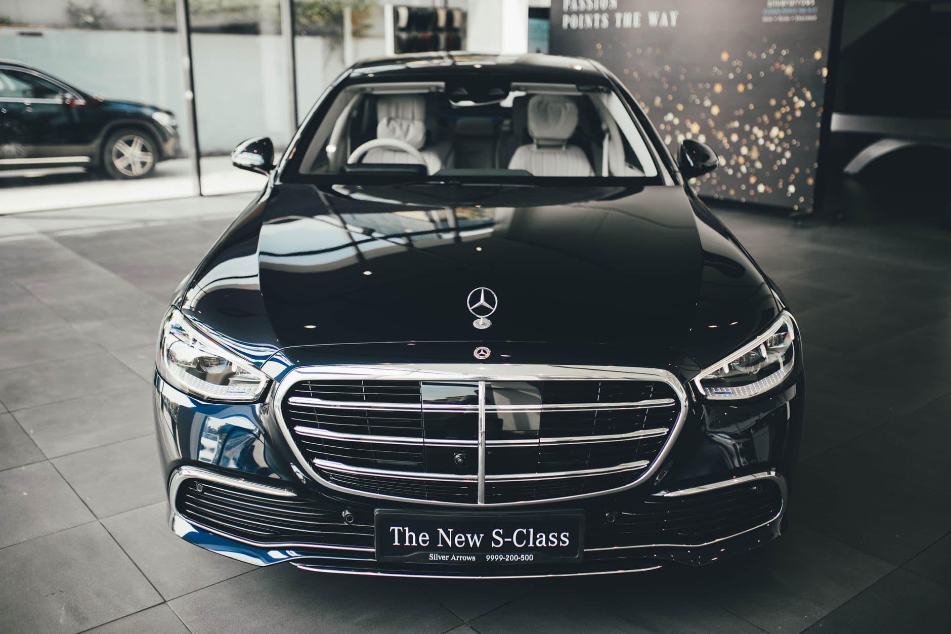 Website & Hosting for Automobile Businesses — Front view of a luxury Mercedes-Benz S-Class on display in a New Delhi showroom.