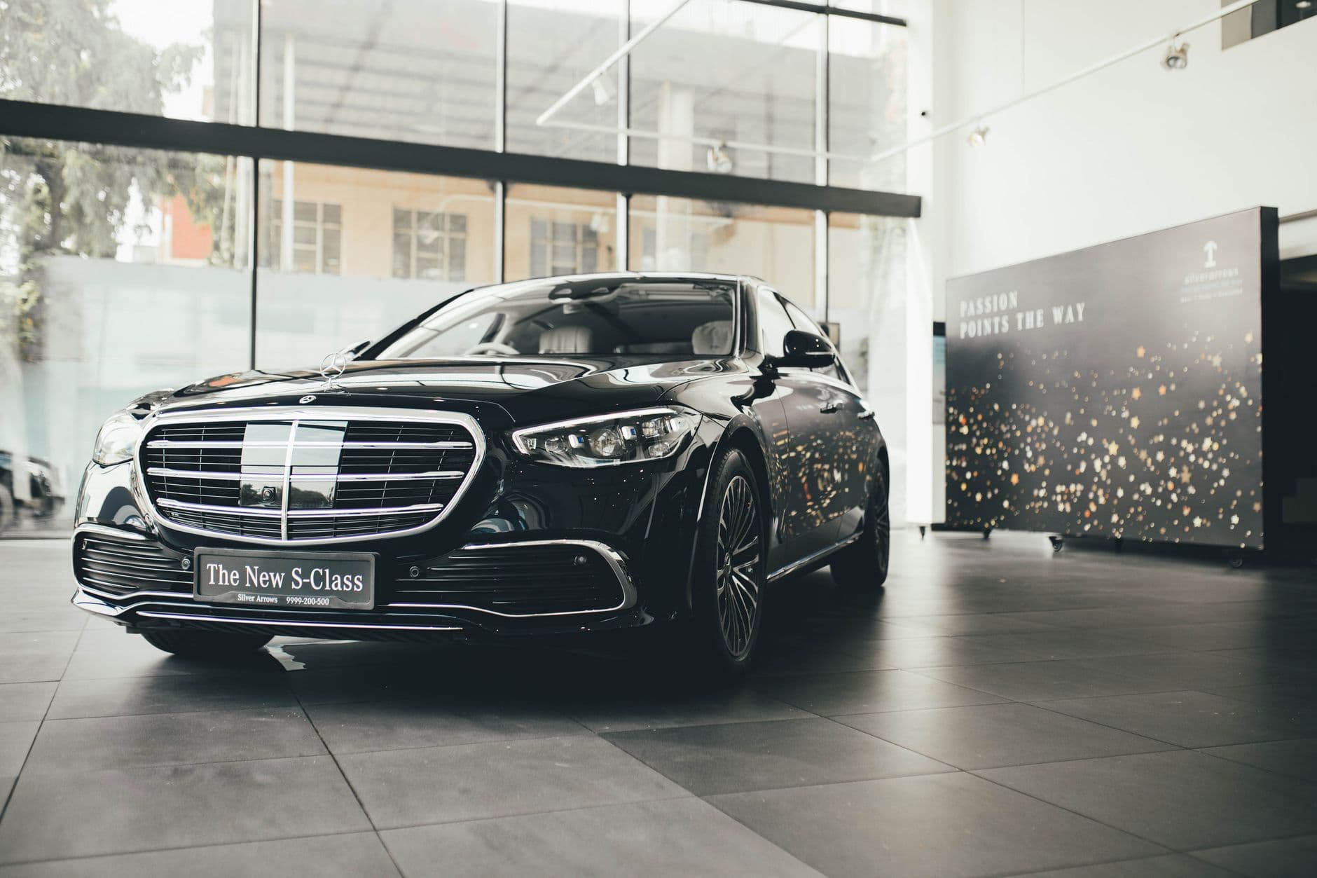 Website & Hosting for Automobile Businesses — Elegant Mercedes-Benz S-Class showcased in a classy New Delhi showroom, highlighting modern luxury.