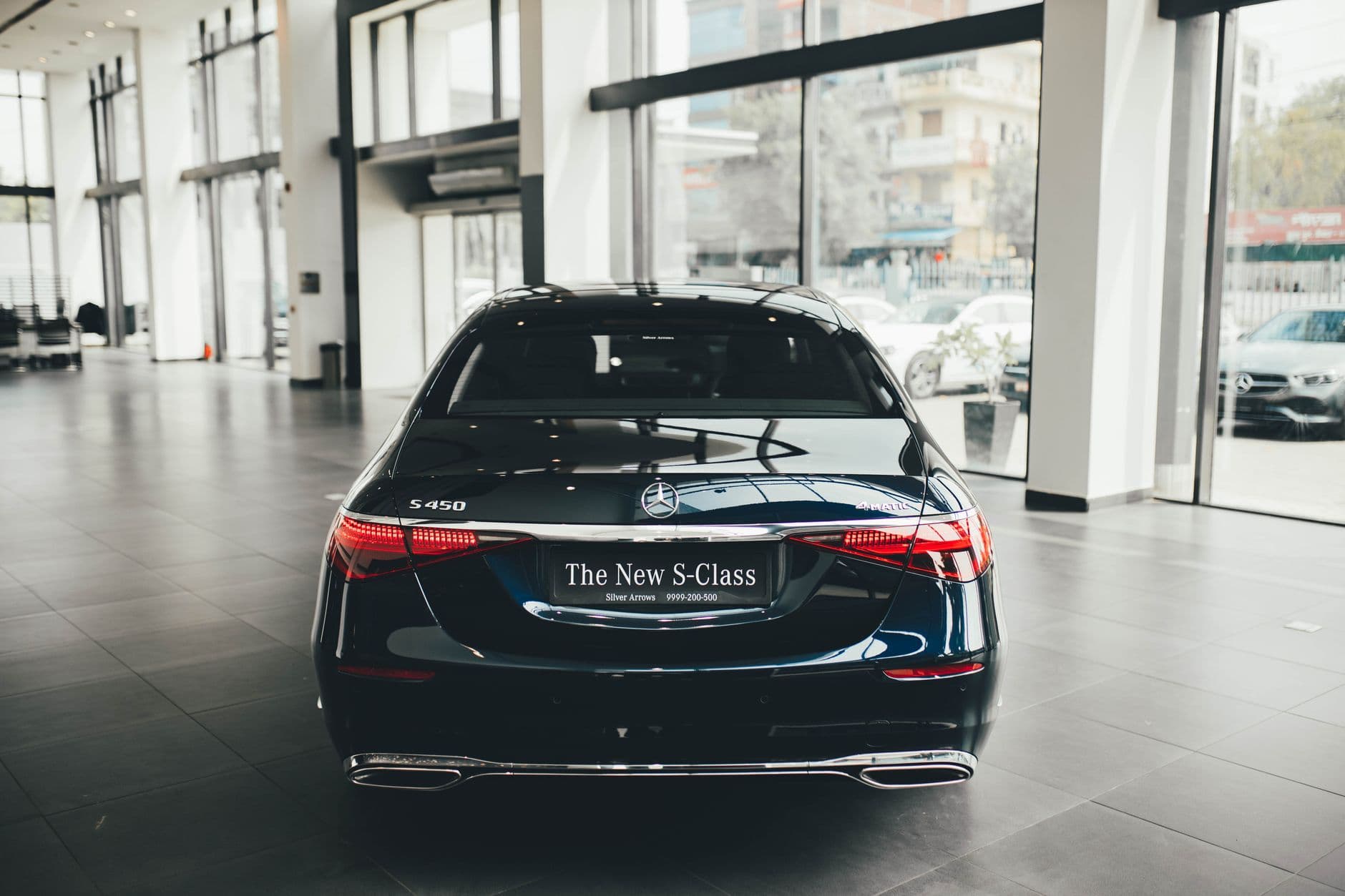 Website & Hosting for Automobile Businesses — Rear view of a sleek Mercedes S450 in a modern car dealership showroom, New Delhi.