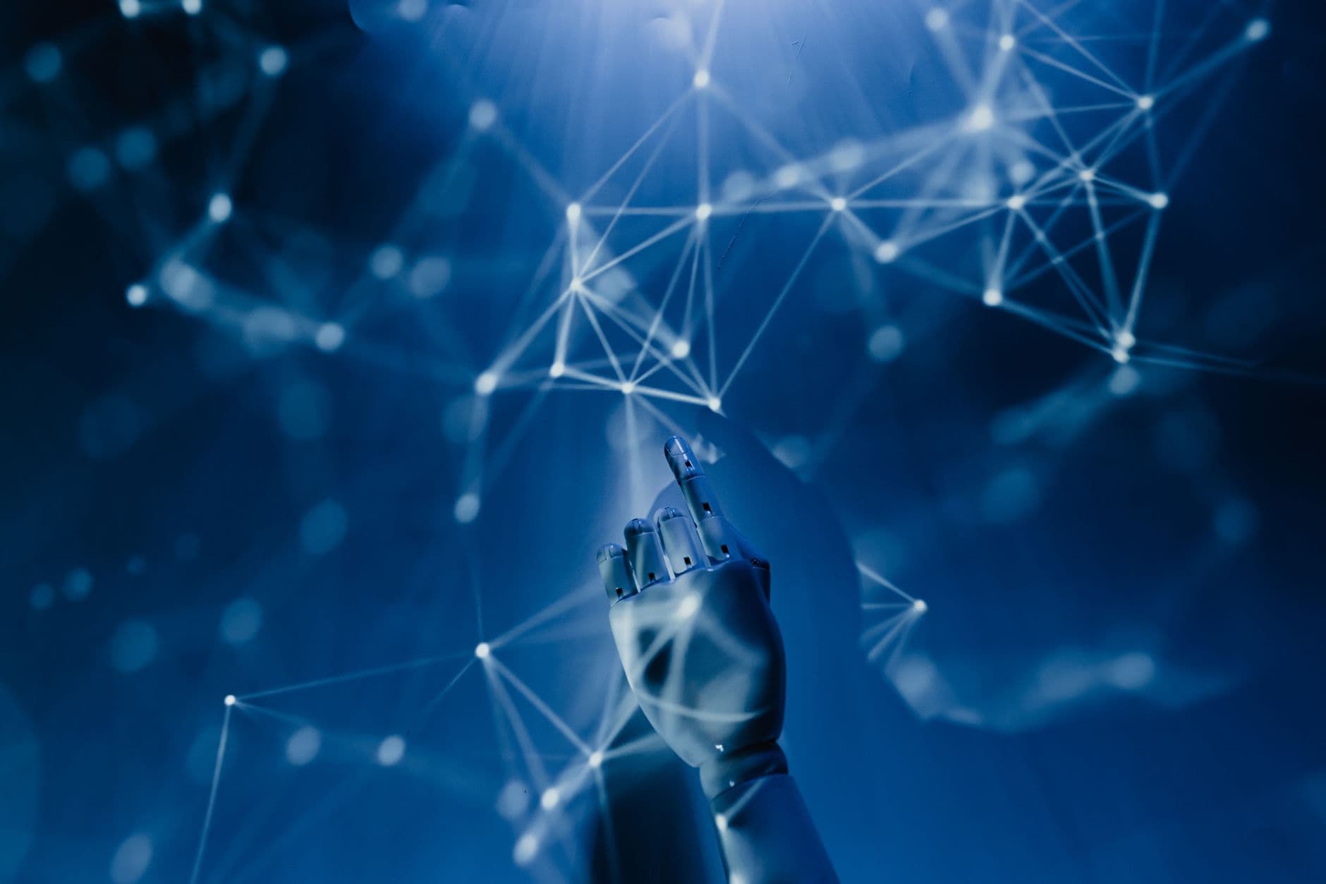 AI Automation — A robotic hand reaching into a digital network on a blue background, symbolizing AI technology.