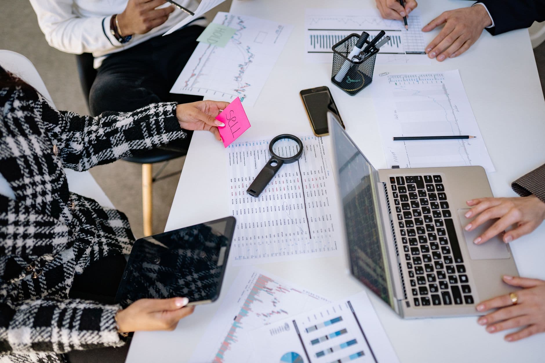 Marketing Automation — Business professionals collaborating on financial data analysis in a modern office setting.