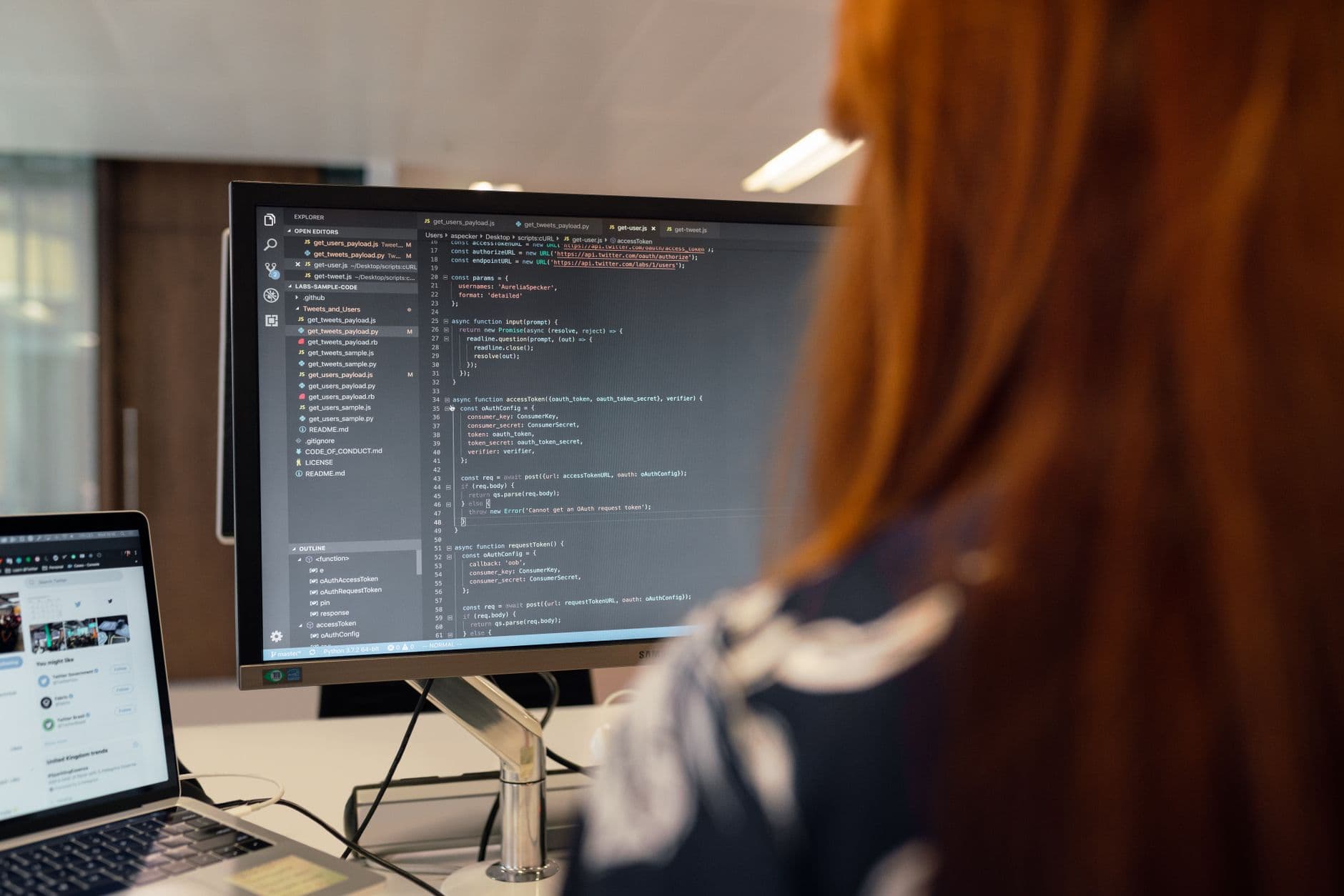 Website Development — A female engineer works on code in a contemporary office setting, showcasing software development.