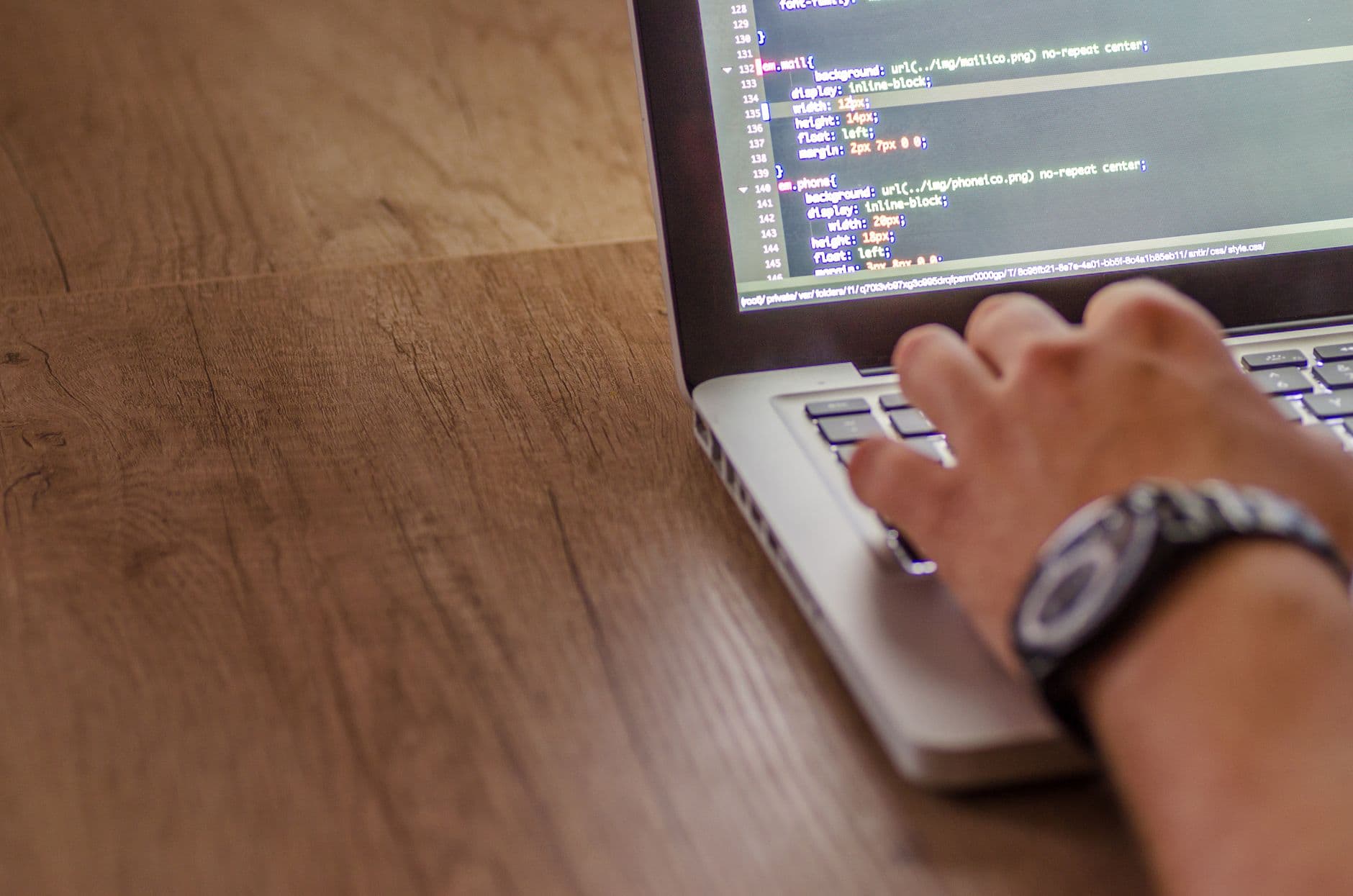 WordPress Hosting — Close-up of a person coding on a laptop, showcasing web development and programming concepts.