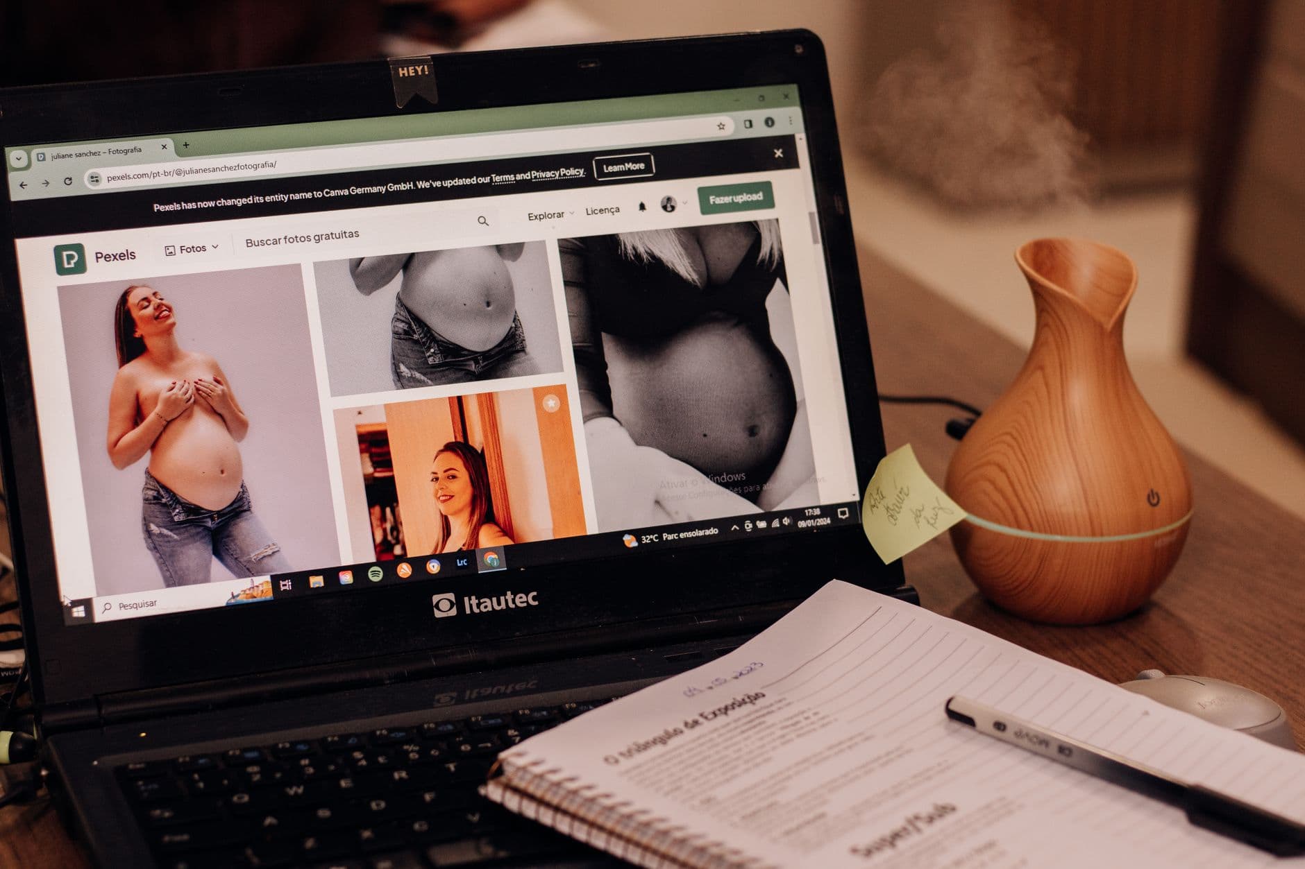WordPress Hosting — A laptop displays pregnancy images online beside a notepad and vase on a desk, emphasizing health and lifestyle.