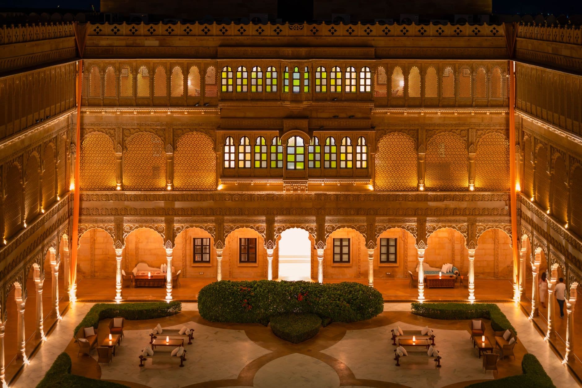 Hotel Booking Websites — Stunning night view of a beautifully lit palace courtyard in Jaisalmer, Rajasthan, India, showcasing exquisite architecture.