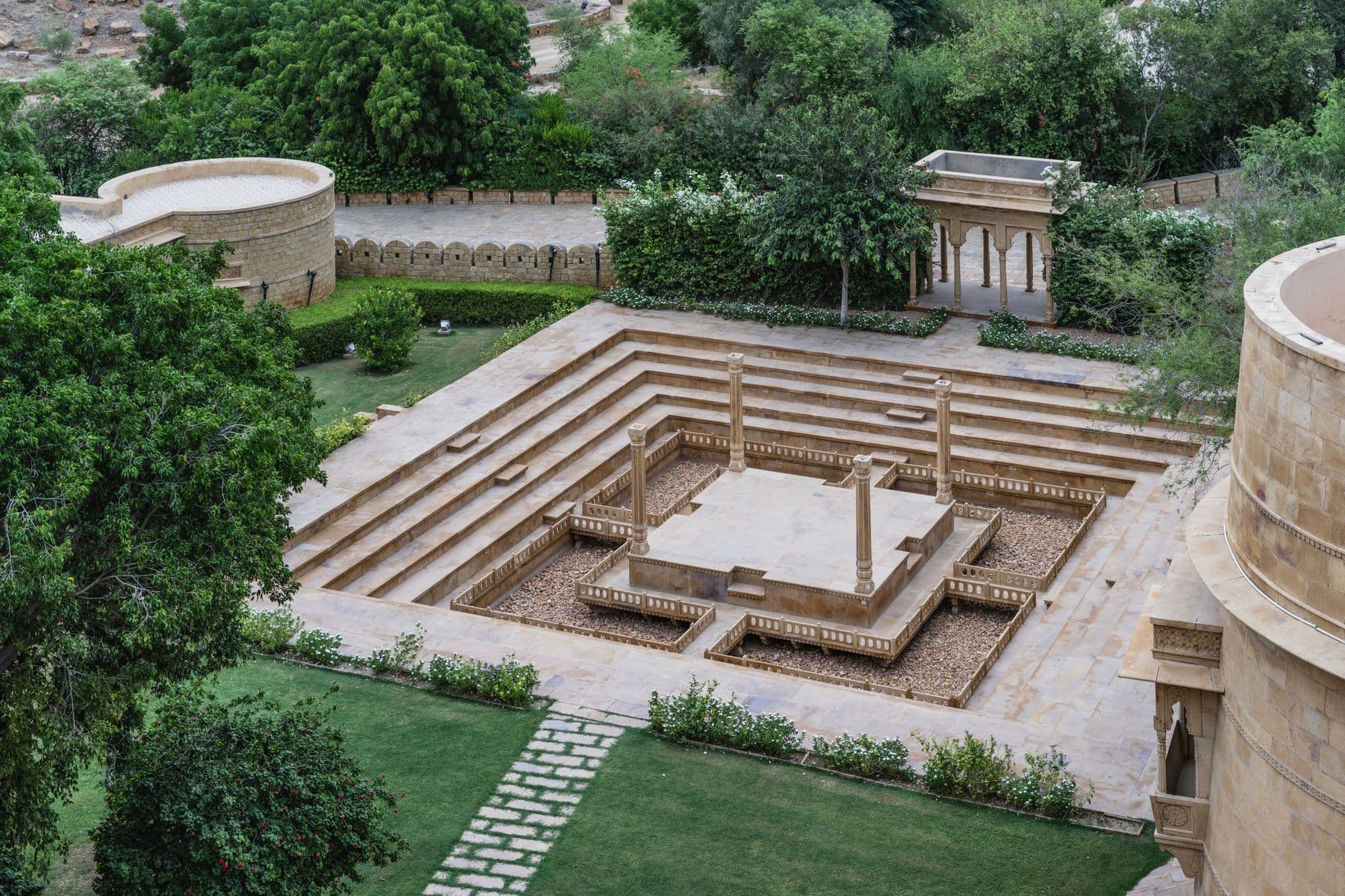 Hotel Booking Websites — Aerial view of the sandstone courtyard at Suryagarh, Jaisalmer, showcasing Rajasthan's architectural elegance.