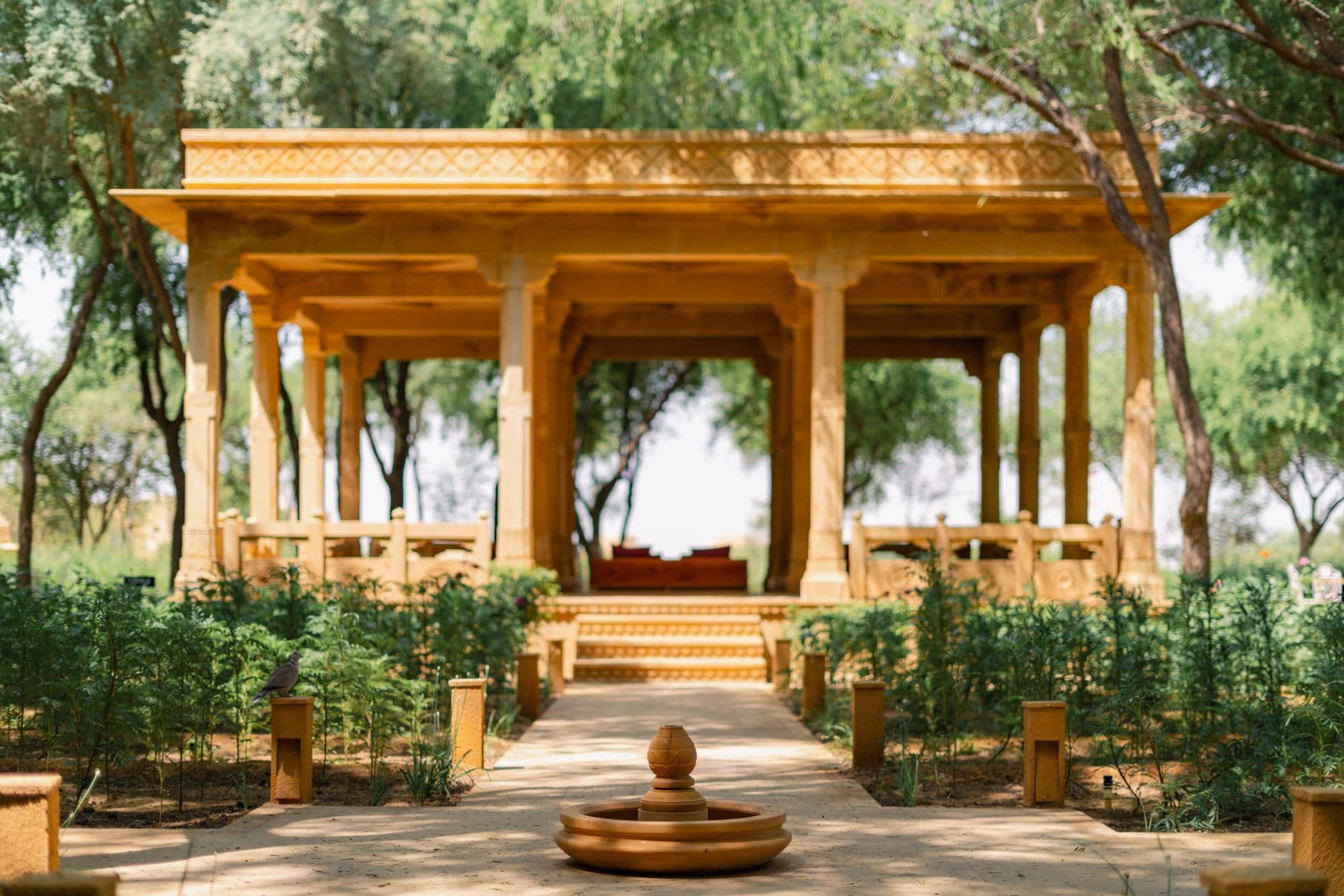 Hotel Booking Websites — Explore the serene traditional courtyard at Suryagarh Hotel, Jaisalmer, India. Ideal for cultural experiences.