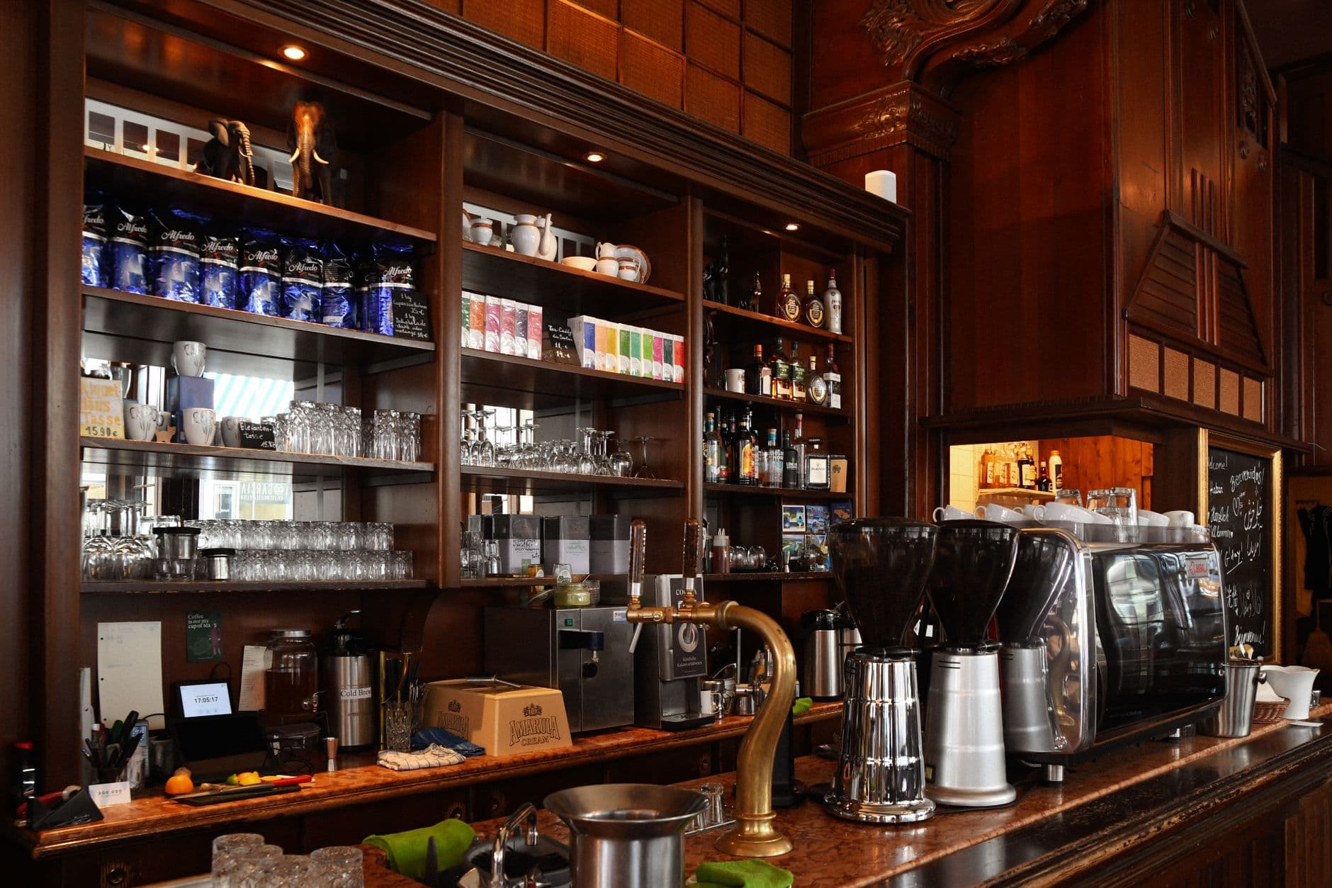 Website & Hosting for Cafes — Elegant coffee shop counter displaying an espresso machine and various drinks.