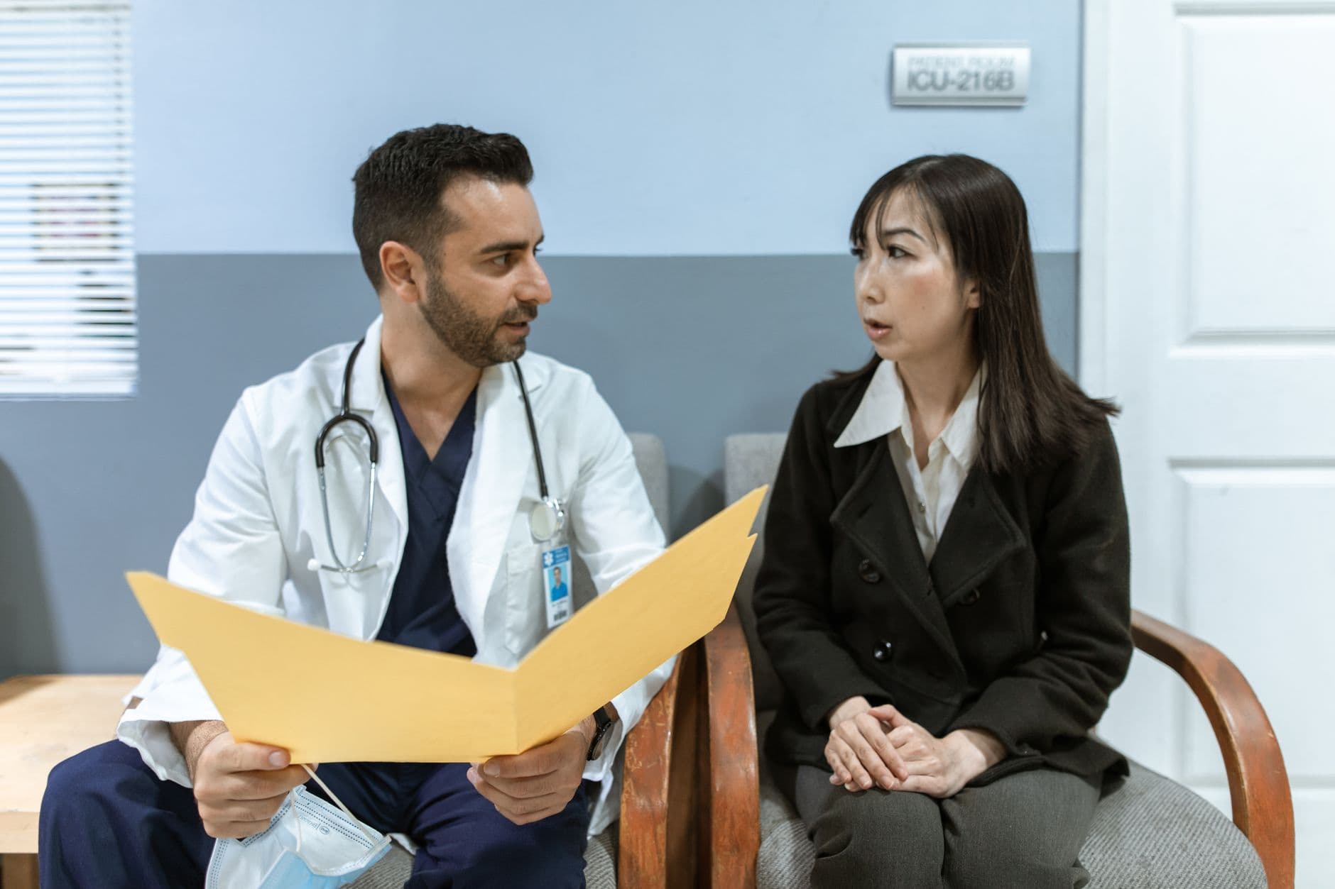Website & Hosting for Doctors — Healthcare professional consults patient in clinical setting. Medical discussion and diagnosis.