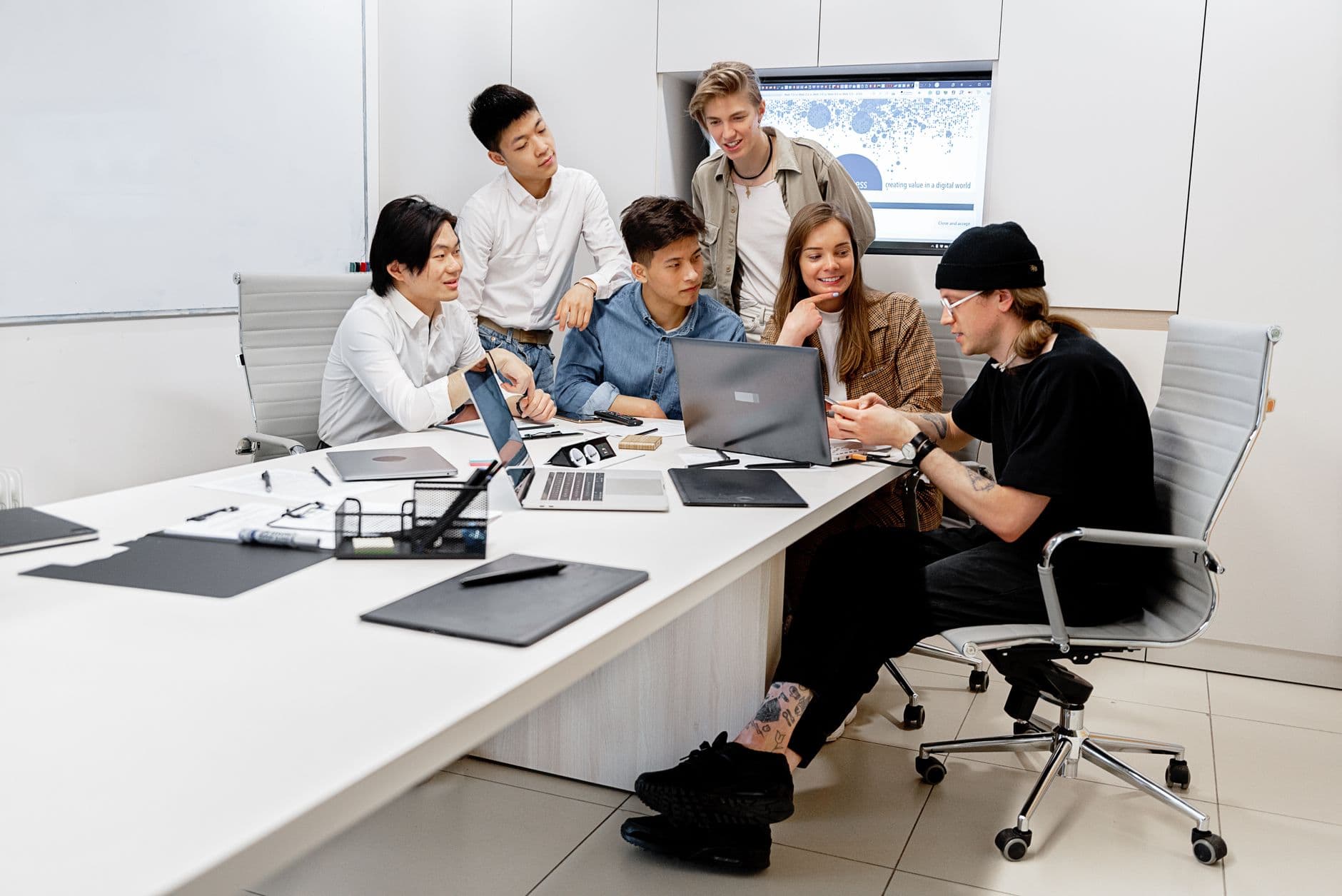 Website & Hosting for Startups — A diverse group of young professionals collaborating on a project in a bright modern office environment.